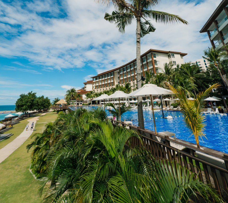 Resort pool surrounded by palm trees
